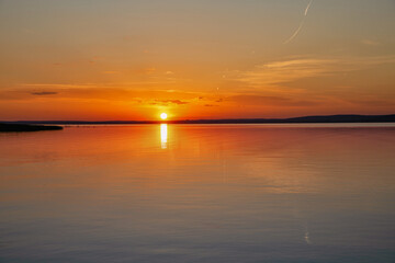 Spectacular sunset over lake Balaton with golden reflections, Hungary.