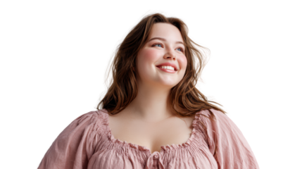 Smiling woman with wavy hair, wearing a pink blouse, natural light glowing against an isolated background.