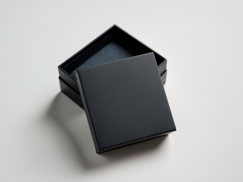 Empty black jewelry or gift box with the lid off. Elegant, minimalist packaging mockup on a white background.