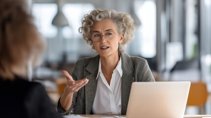 Middle-aged woman sitting at a modern office desk