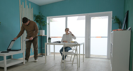 Fototapeta premium millennial man and woman working in small office discussing documents