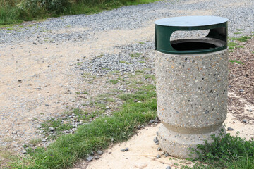 Public litter bin by gravel path