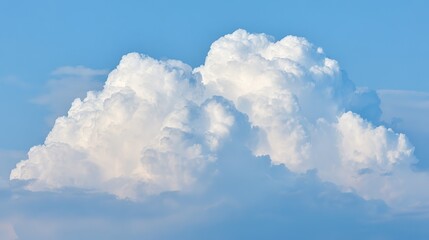 Naklejka premium Fluffy cumulus cloud in blue sky, embodying peace and vastness of summer