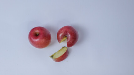 Red apple with a bite on side, showing white flesh inside, isolated on white background.Half apple...