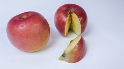 Red apple with a bite on side, showing white flesh inside, isolated on white background.Half apple with red apple isolated. Apple on white background. Red apple with clipping path. Full depth of field