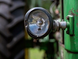 Close-up of round mechanical gauge on vintage green agricultural machinery