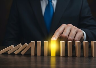 Businessman with a touch stops process of falling dominoes. Successful strong business and solve all accumulated problems. Stop destructive processes. Risk management concept. Debt restructuring
