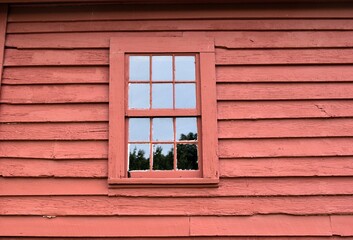 red window on a wooden wall