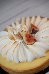 Sunny and Bright Orange Lemon Citrus Meringue Pie on a black plate on white background. High quality photo