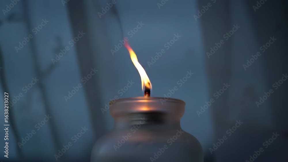 Poster close-up of a single candle flame burning, creating a warm, peaceful mood with candle light in the s