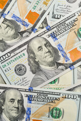 Large fragment of the obverse side of 100 one hundred dollar banknote. Set of American dollar bills. Vertical image.