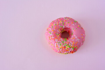 Pink Frosted Donut with Colorful Sprinkles copy space