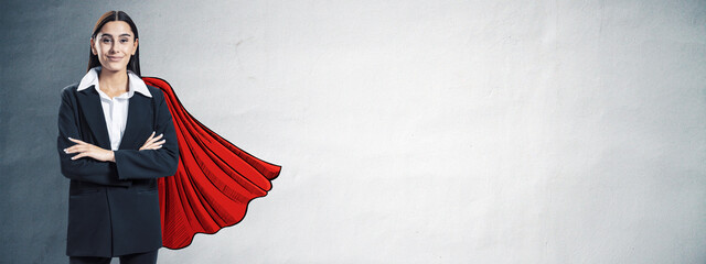 Confident businesswoman in suit with red superhero cape sketch standing against clean wall...