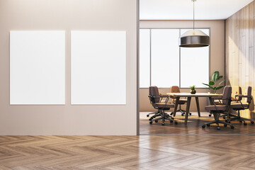 Two vertical blank posters on modern office wall beside conference room with wooden floor and city...