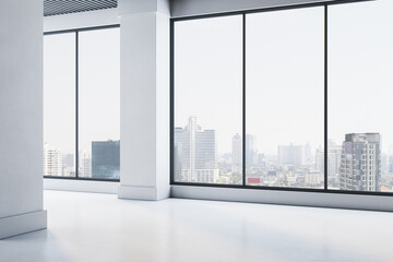 Modern empty office interior with large windows and city skyline view in background, featuring...