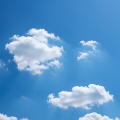 Fototapeta premium Expansive bright blue sky with soft white cumulus clouds floating serenely on a clear sunny day, a perfect natural background.