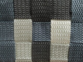 Fototapeta premium Close-Up of Woven Plastic Texture in Black, Gray, and Beige Checker Pattern