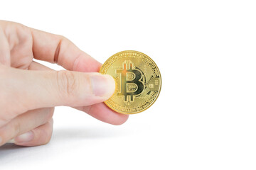 A male hand holds a shiny golden Bitcoin cryptocurrency coin against a clean white background, symbolizing digital finance, investment, and modern technology.