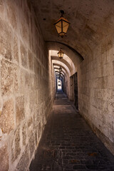 Obraz premium The historic streets of Arequipa weave through centuries of tradition, lined with sillar stone walls, ornate balconies, and echoes of colonial elegance, inviting you to walk through the city’s living 