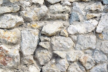 Creative background from a part of a wall made of natural stone
