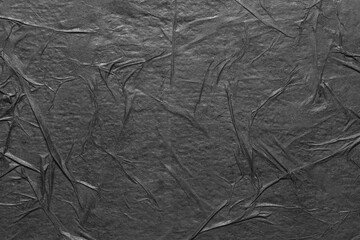 Texture of black paper with folds.