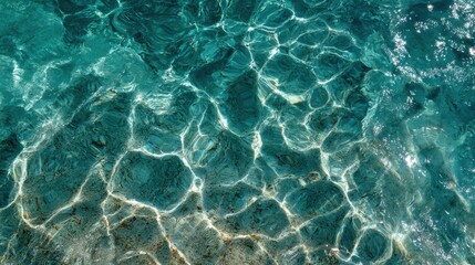 A close-up view of crystal-clear turquoise water showcasing beautiful light reflections and textures.