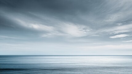 A serene ocean view under a dramatic sky, showcasing calm waters and atmospheric cloud formations.