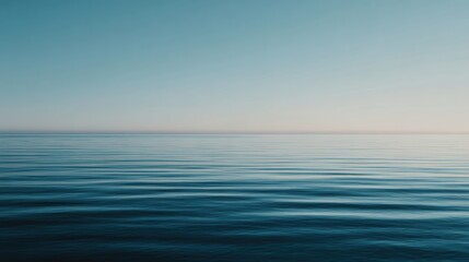 Obraz premium A serene ocean view showcasing calm waves under a clear blue sky, perfect for relaxation and nature themes.