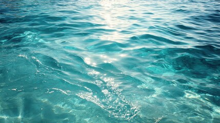 Obraz premium A serene view of clear aqua water reflecting sunlight, perfect for conveying tranquility and natural beauty.