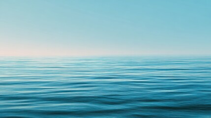Obraz premium A serene view of calm ocean waters under a clear blue sky, representing tranquility and natural beauty.