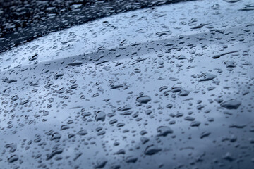 Black car Hood with Hydrophobic Coating. Glistening Raindrops on Car