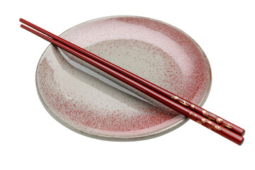 Red lacquered chopsticks resting on speckled ceramic plate isolated on a transparent background image