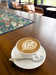 Ralistic coffee cup with heart shape made of froth latte