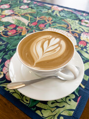 Ralistic coffee cup with heart shape made of froth latte