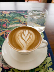 Ralistic coffee cup with heart shape made of froth latte