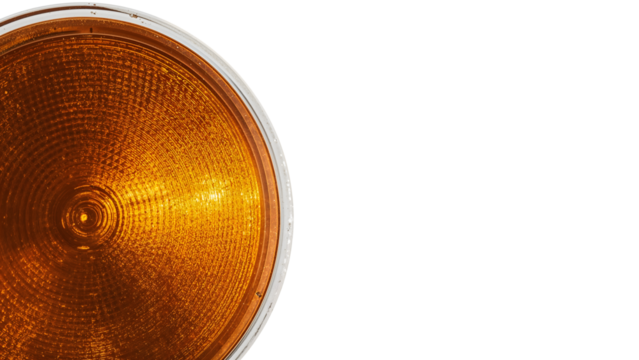 Closeup of amber traffic light lens on the transparent background highlighting circular pattern and texture - Powered by Adobe
