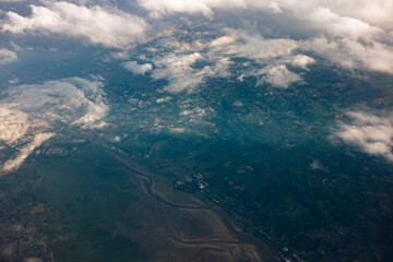 Aerial view of Irish countryside showing fields rivers and scattered clouds from above. Rural...
