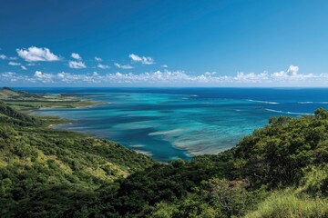 A scenic elevated view shows turquoise coastal waters and verdant green hills under a bright blue sky with scattered clouds
