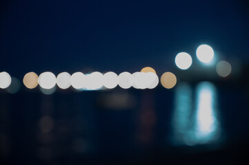 Bokeh on night background. Blurred glowing lights on horizon