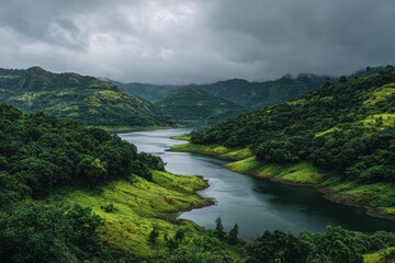 Serene river winding through lush green mountains under a dramatic cloudy sky