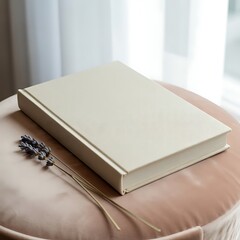 Fototapeta premium Elegant cream-colored book mockup with lavender sprigs on a blush-pink surface.