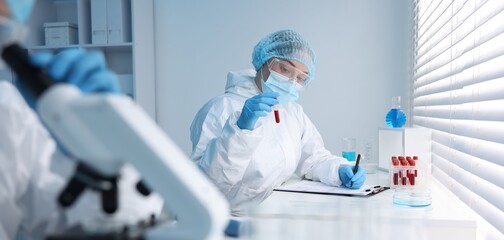 Medical analysis. Scientist working with blood sample in laboratory, selective focus