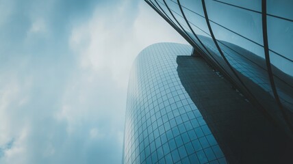 Low angle view of modern glass skyscrapers against a cloudy sky glass building modern architecture