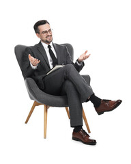 Professional psychologist with notebook in armchair on white background