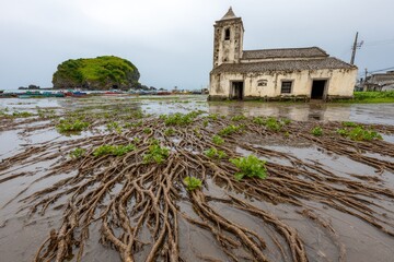 Flooded waterfront with church and island
