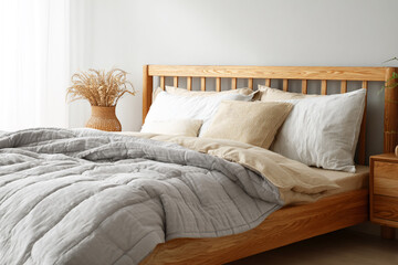 Product photography, bedroom scene, wooden bed with a grey quilt on it, light beige and white style.