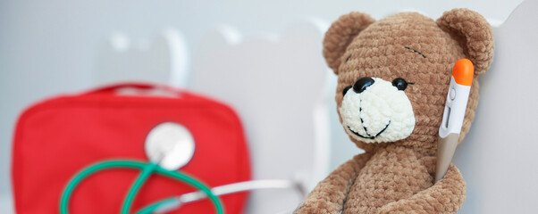 Pediatrician concept. Toy bear, thermometer, medical bag and stethoscope on chairs in clinic, closeup. Space for text