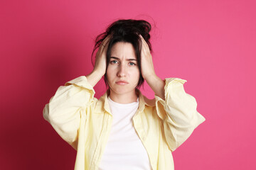 Woman suffering from hangover on crimson background