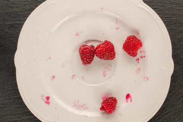 Sweet ripe raspberries on slate stone, macro, top view.