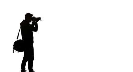 Silhouetted photographer with camera bag